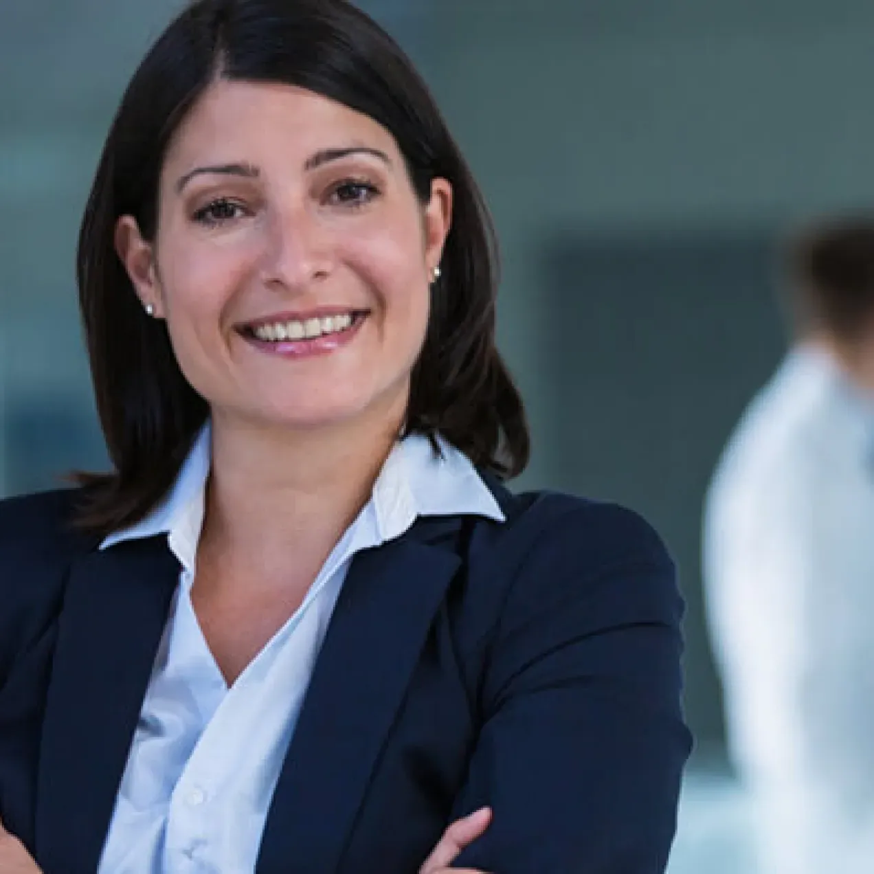 Nurse Leader with Healthcare Administrators in Meeting in Background 